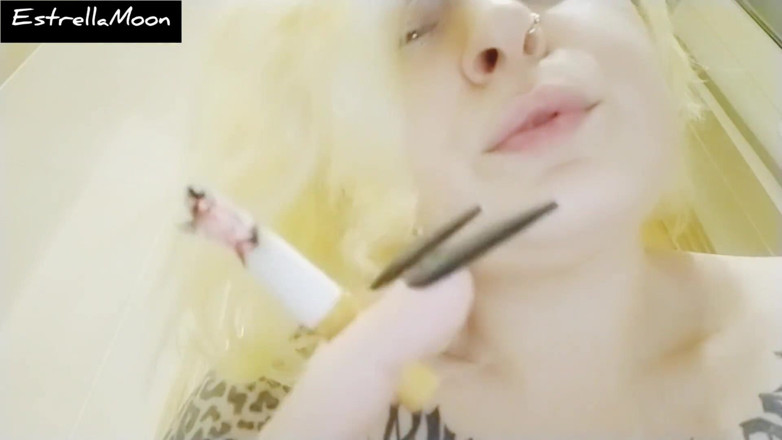 Estrella Steam: Gros plan - une blonde aux longs ongles fume un Cigarettes