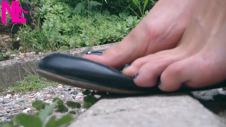 Nyllady: Schoenspel met zwarte leren flats op blote voeten buiten